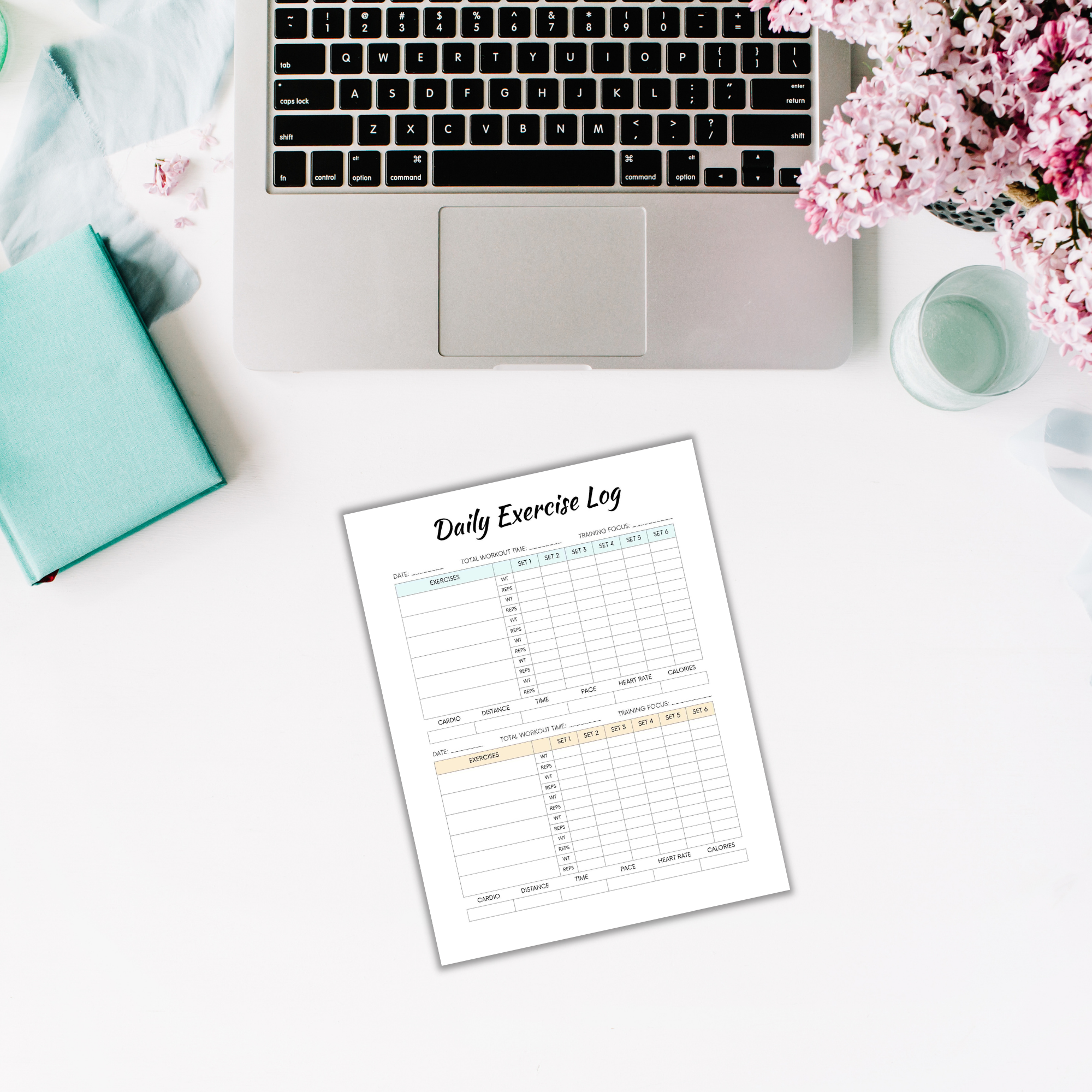 A laptop, notebook, and flowers adorn the desk, with a "Daily Exercise Log" sheet from the "Fitness Planner PLR" laid out in front—perfect for those dedicated to their fitness planning journey.
