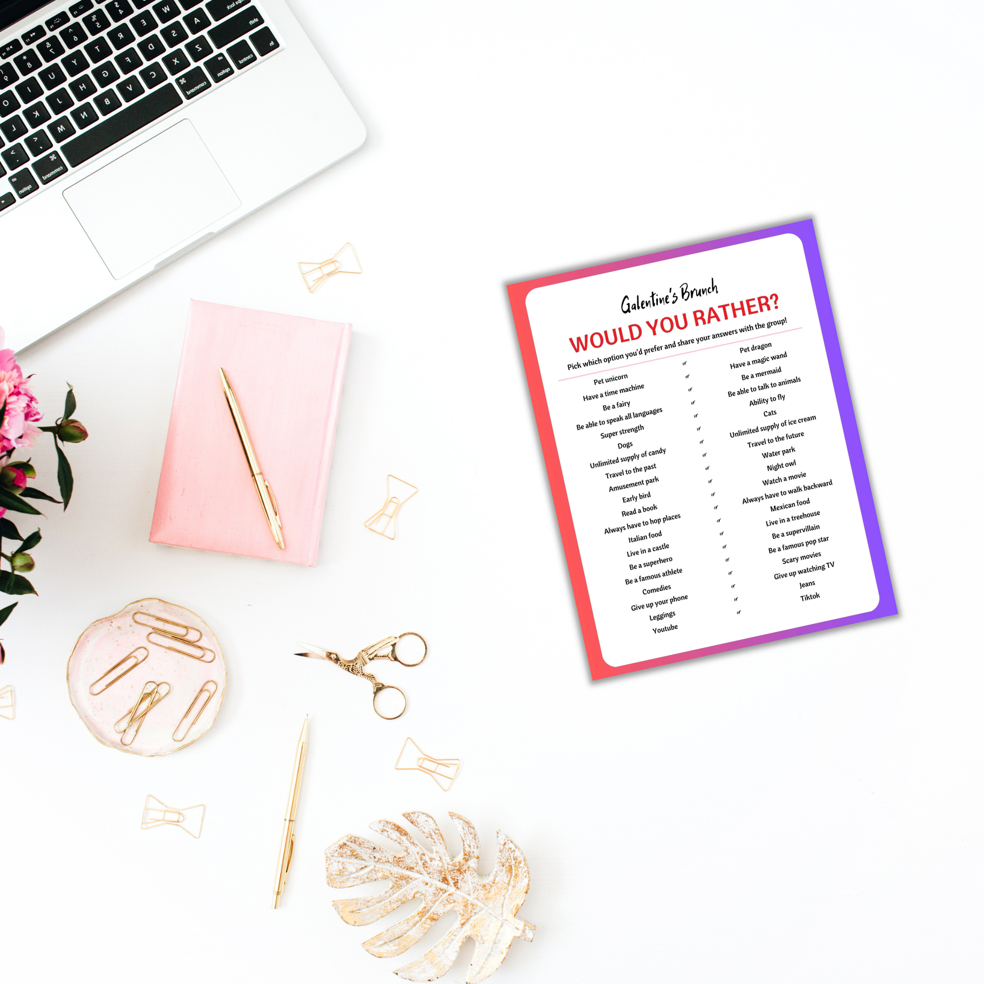 At a Galentines Brunch setup on a white desk, the "Galentines Brunch Invitation & Party Games PLR" card awaits, nestled among a laptop, pink notebook, gold paperclips, scissors, pink flowers, and a decorative leaf — perfect for infusing some fun into the celebration.