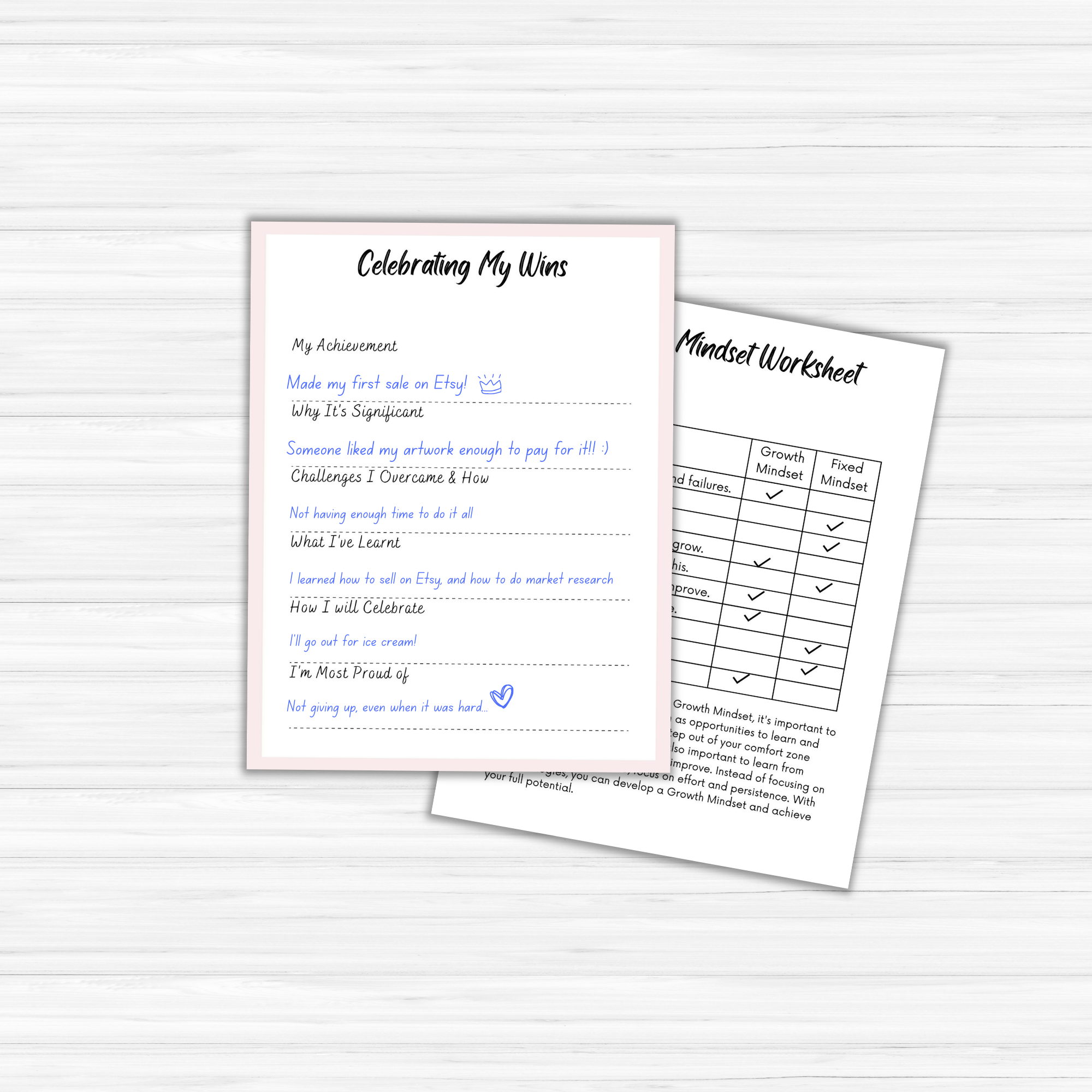 On a light wood surface, two "The Glow Getter" worksheets are displayed. On the left, a "Celebrating My Wins" worksheet highlights handwritten achievements that embody the spirit of a true glow getter. On the right, a "Mindset Worksheet" features a grid comparing fixed and growth mindsets, ideal for anyone excelling in their personal development journey.
