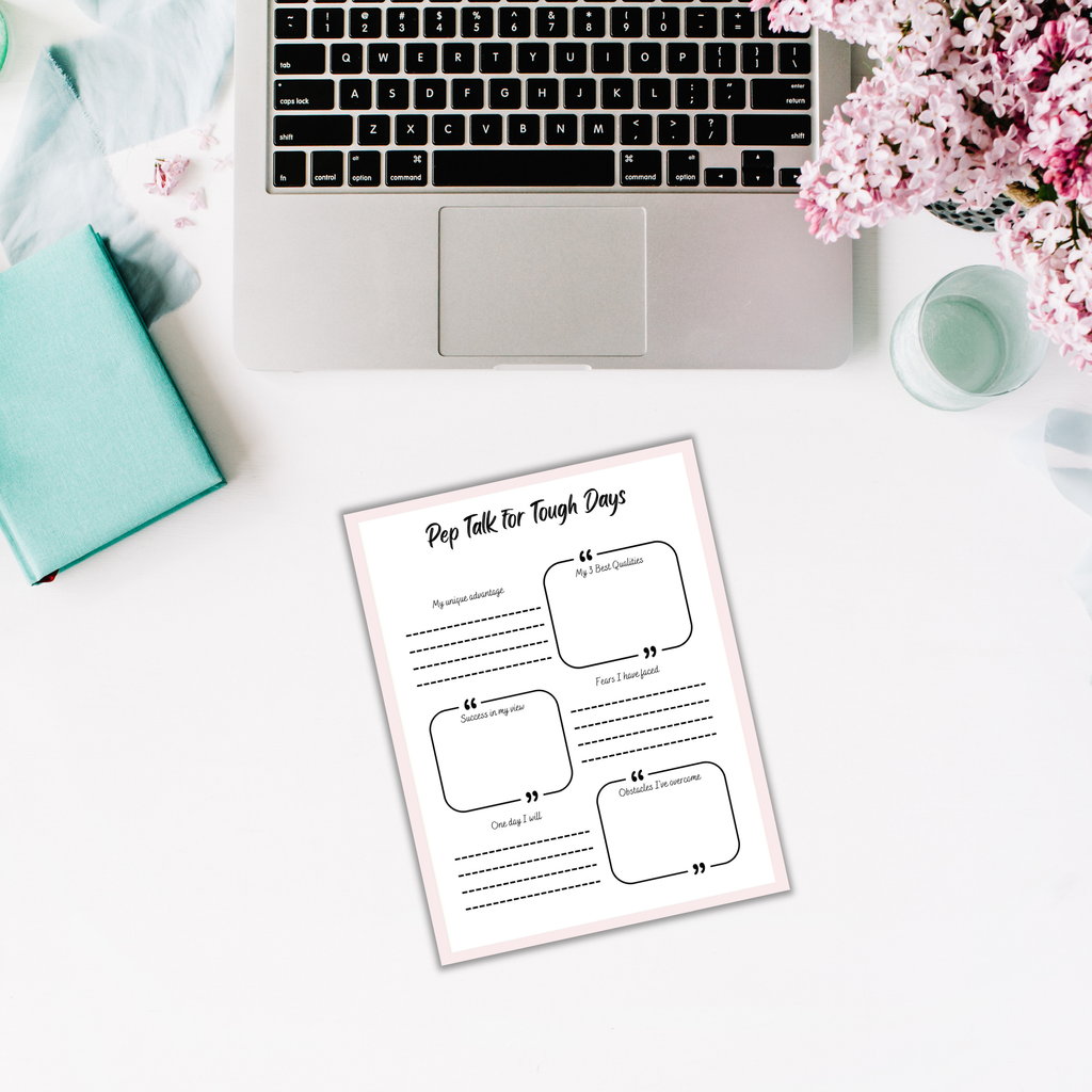 A laptop rests on a white surface beside a green notebook, pink flowers, and a motivational worksheet titled "Pep Talk for Tough Days," ideal for The Glow Getter who is ready to seize every opportunity.