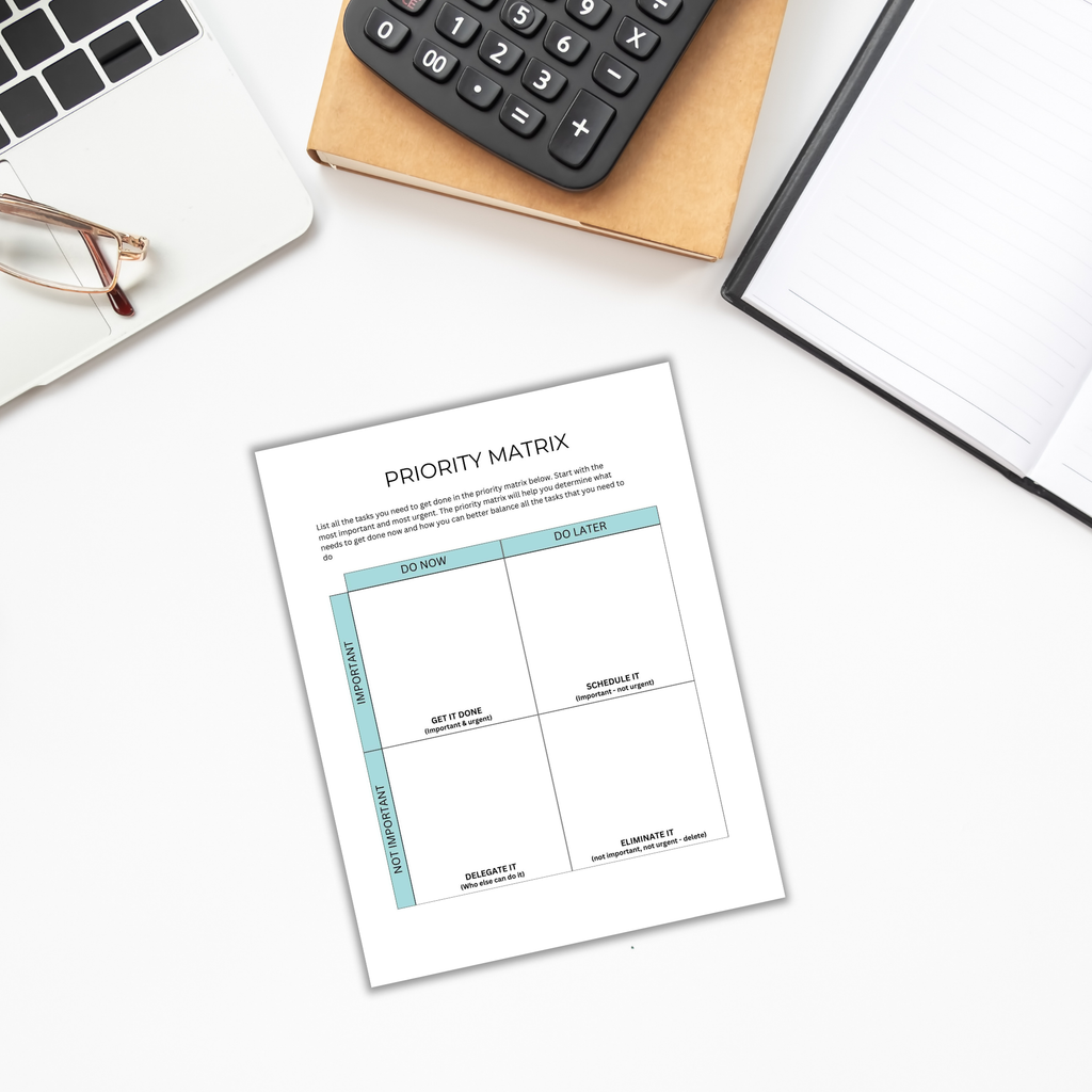 On a desk sits a priority matrix worksheet surrounded by The Goal-Setting Planner, glasses, and a calculator, with an open notebook nearby for goal-setting.