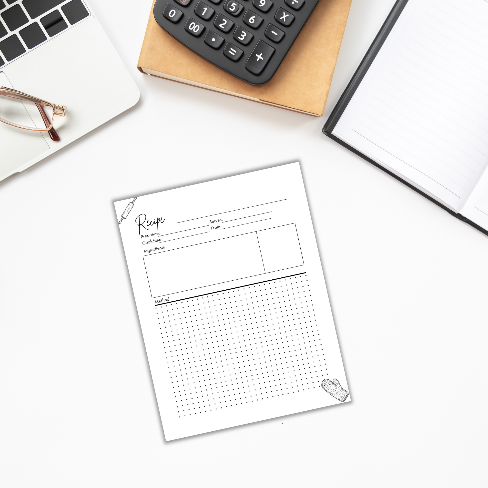 A *MealPrep Magic* recipe sheet, featuring sections for title, ingredients, and instructions, lies on a desk next to a calculator, notebook, and laptop.