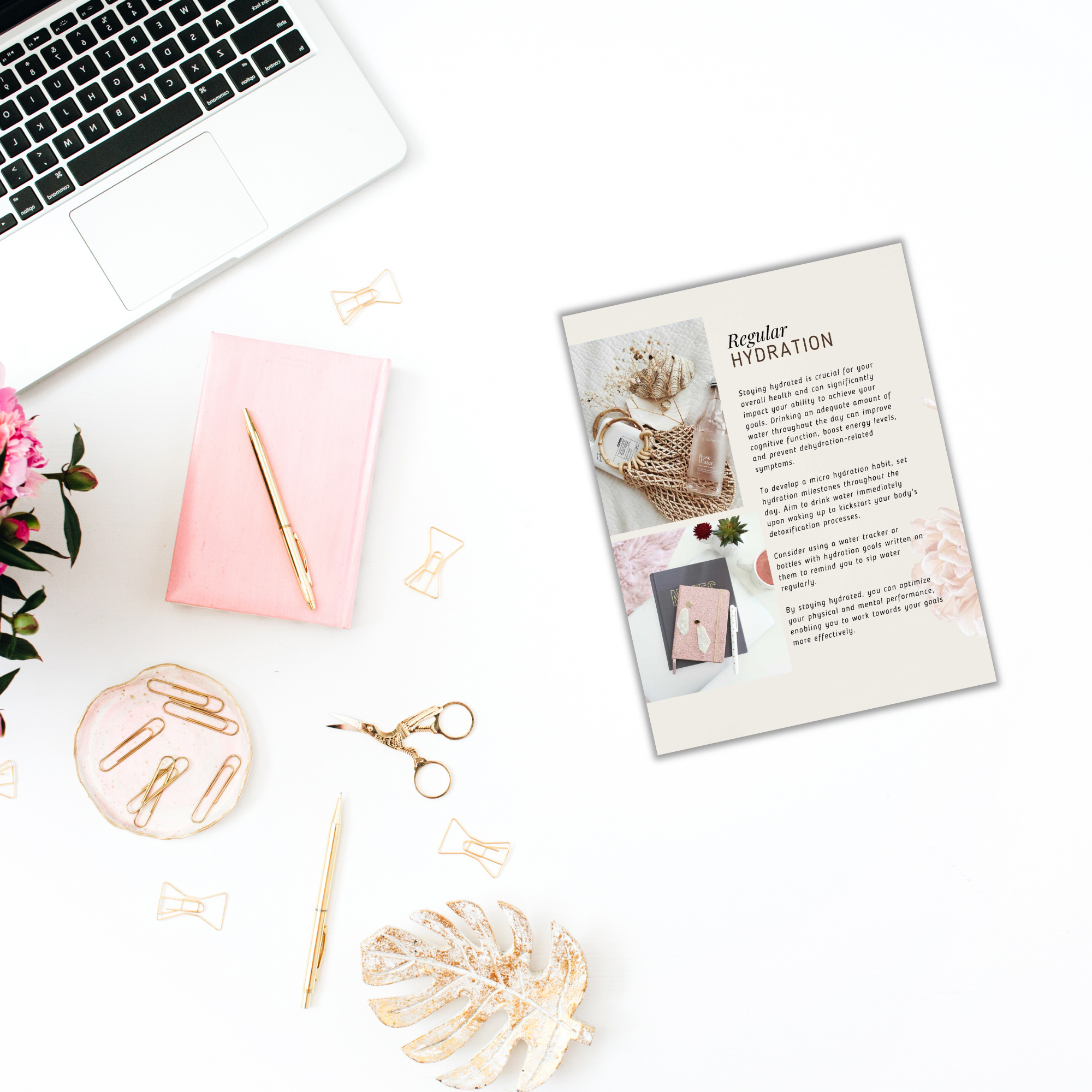 Aerial view of a workspace featuring a laptop, the "Powerful Micro Habits - Ebook & Workbook," a pink notebook, and a gold pen laid next to the open ebook. Scissors, a magazine, and decorative items like pink flowers, a palm leaf, and scattered gold paperclips complete the scene on a crisp white background.