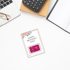 Mother's Day Gift Cards Holder placed on a white desk beside a notebook, calculator, and laptop with glasses.