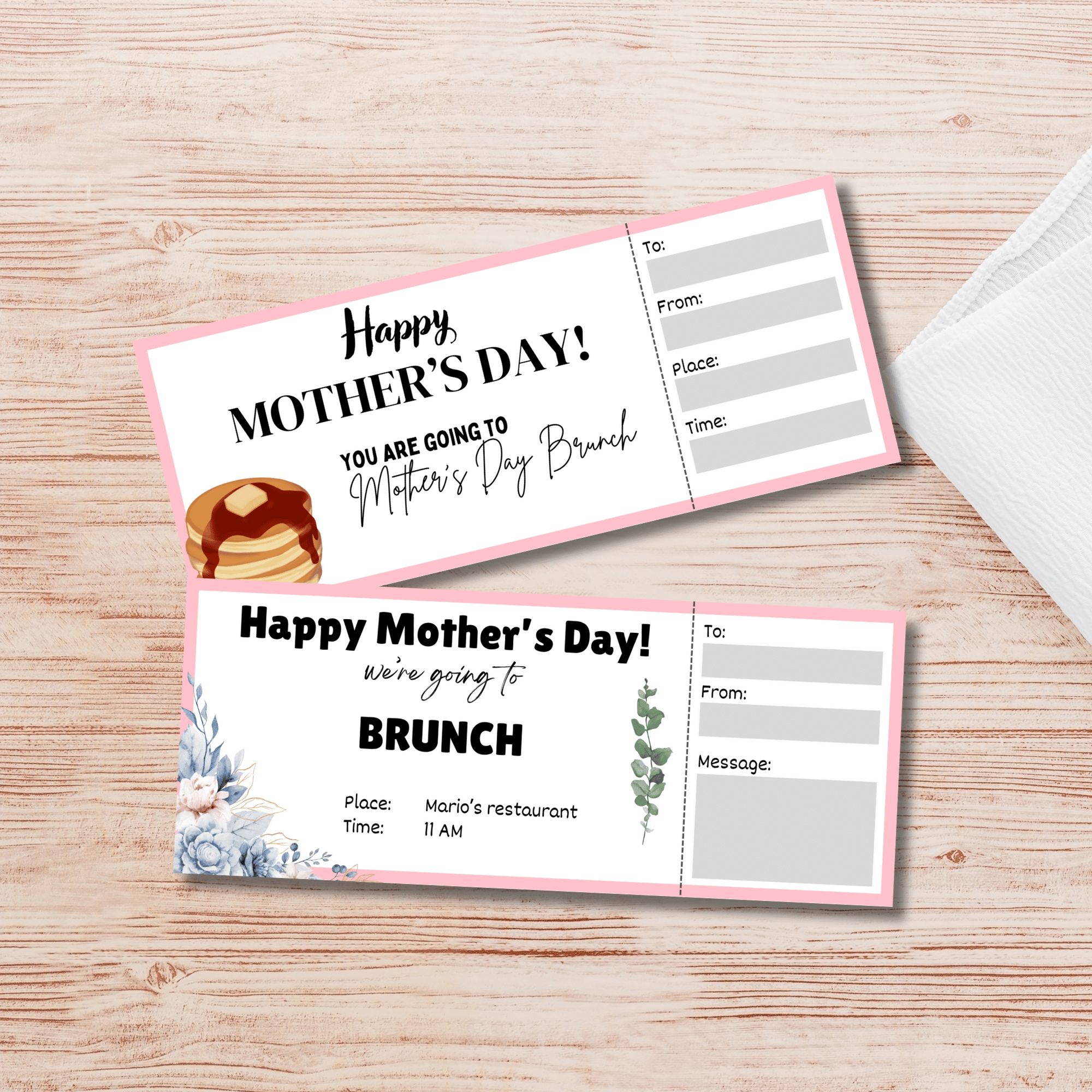 Two Mother's Day brunch invitation cards, featuring floral and pancake graphics, lie on a wooden surface. Spaces are ready for recipient details, making these Mother's Day Activity Placemats PLR designs ideal for hosts of special gatherings.