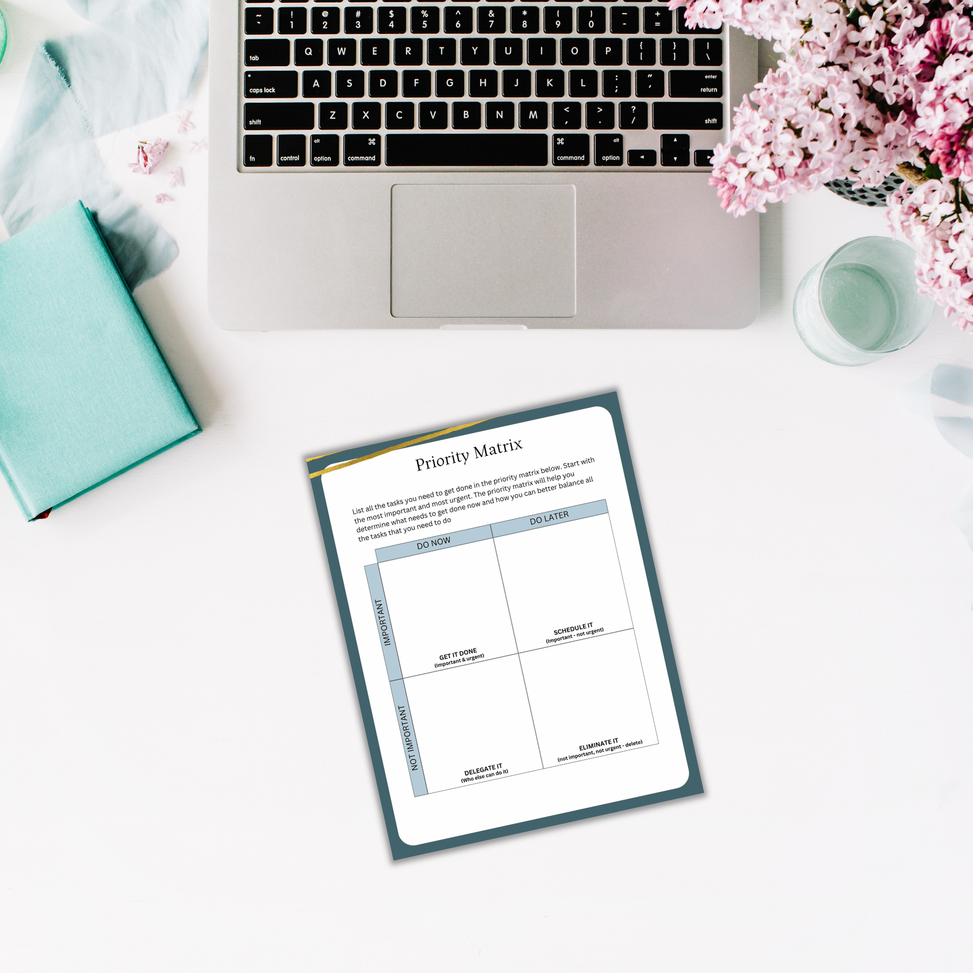 The Solopreneur Success Pack includes a white desk showcasing a laptop and flowers, alongside a priority matrix on paper, symbolizing success.