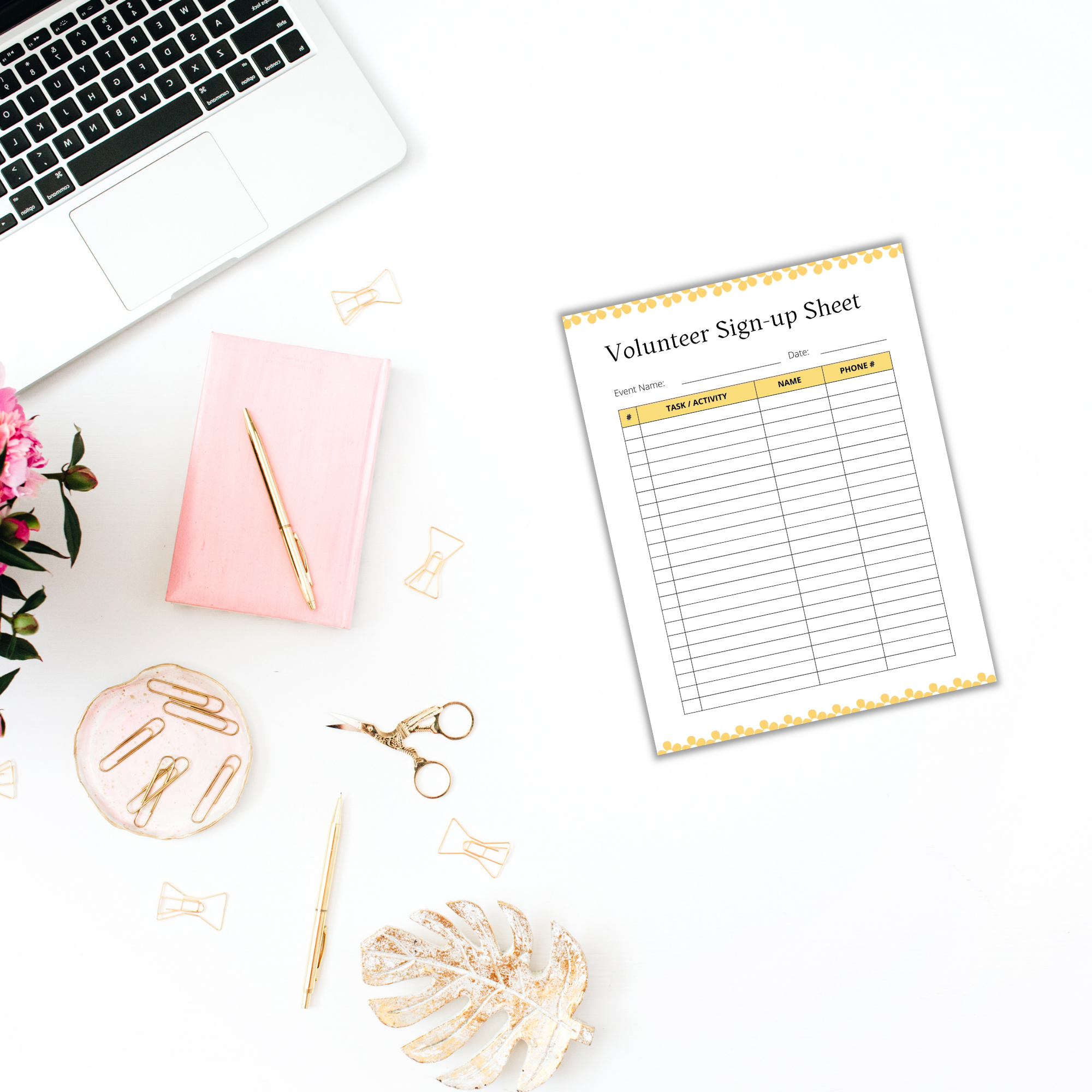 Flat lay featuring an open laptop, a pink notebook, a pink pen, scattered paper clips, scissors, and a volunteer sign-up sheet on a white surface. Add vibrant color and organization to your workspace with the Free: Spring-themed Planner Templates.