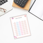 An overhead shot of The Student Success Planner's weekly timetable sheet on a desk, accompanied by a notebook, calculator, glasses, and laptop.