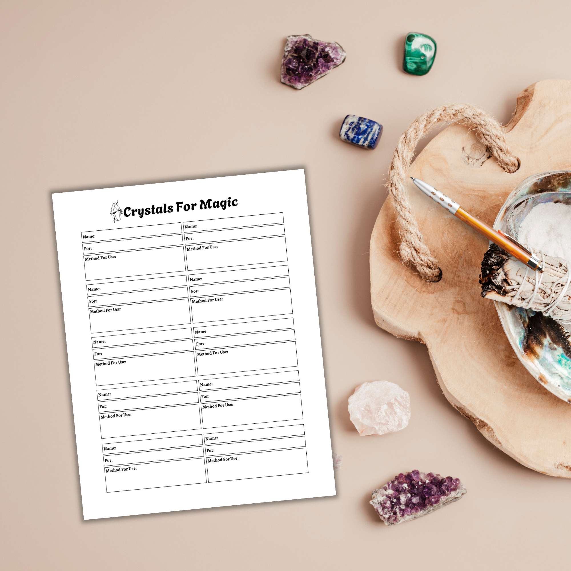 A form titled "Crystals For Magic" sits on a table with a Witchy Planner PLR, sparkling crystals, a pen, and a wooden tray holding a sage bundle and an abalone shell.
